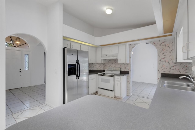 1026 Graham Rd, Venice, FL 34293 - kitchen featuring stainless steel fridge with ice dispenser, white range with electric cooktop, under cabinet range hood, and light tile patterned floors