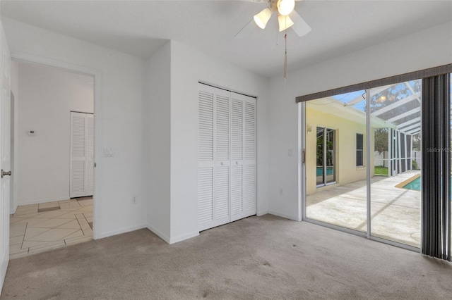 1026 Graham Rd, Venice, FL 34293 - unfurnished bedroom featuring access to exterior, carpet, a closet, and ceiling fan