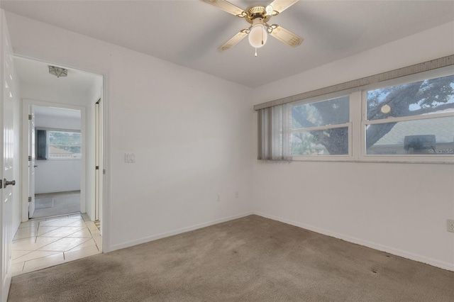 1026 Graham Rd, Venice, FL 34293 - empty room featuring light colored carpet, ceiling fan, and light tile patterned floors