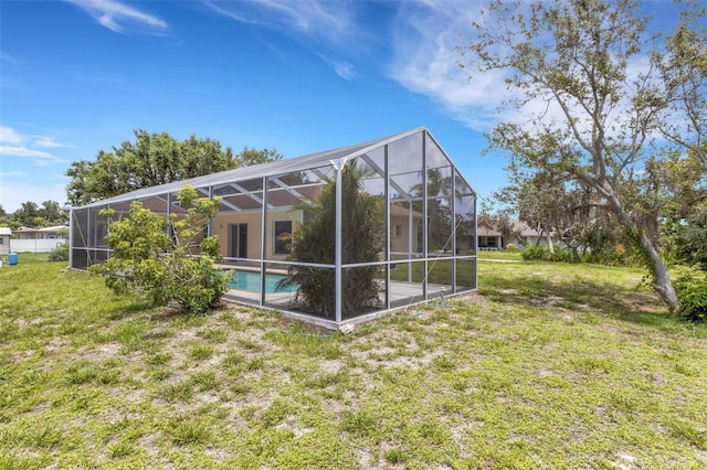 1026 Graham Rd, Venice, FL 34293 - rear view of house with an outdoor pool and a lawn