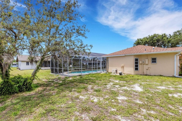 1026 Graham Rd, Venice, FL 34293 - view of grassy yard with an outdoor pool and a lanai