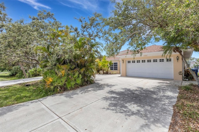 1026 Graham Rd, Venice, FL 34293 - view of front of home with stucco siding, concrete driveway, and an attached garage