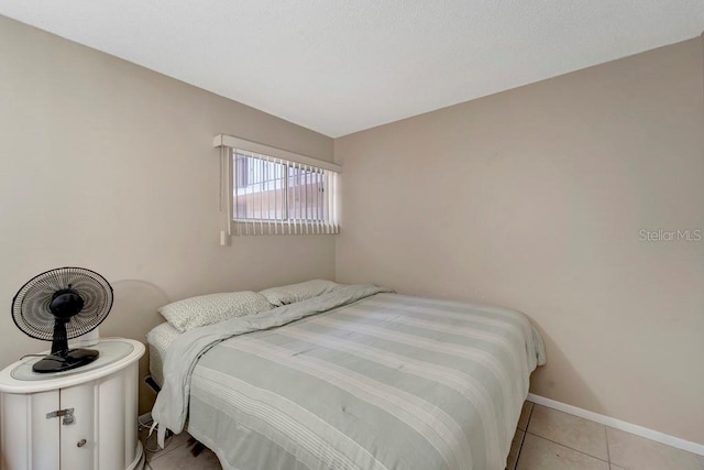 2763 Woodgate Ln Unit 211, Sarasota, FL 34231 - bedroom with light tile patterned floors and baseboards