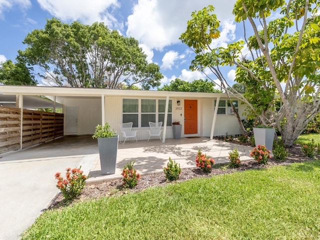 2933 Michigan St, Sarasota, FL 34237 - view of front of house featuring a front lawn, an attached carport, and concrete driveway