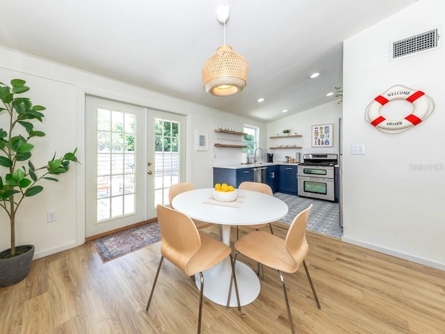 2933 Michigan St, Sarasota, FL 34237 - dining space with light wood-type flooring, french doors, lofted ceiling, and recessed lighting