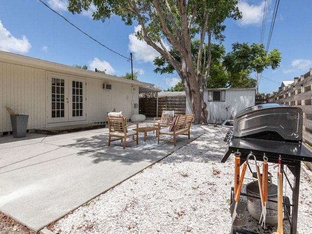 2933 Michigan St, Sarasota, FL 34237 - view of patio featuring french doors, an outdoor hangout area, grilling area, and an outbuilding