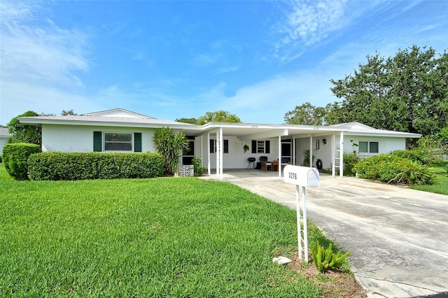 3276 Westford Ln, Sarasota, FL 34231 - ranch-style home featuring concrete driveway, a front lawn, a carport, and stucco siding
