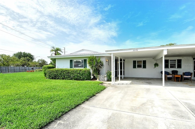 3276 Westford Ln, Sarasota, FL 34231 - view of front facade featuring a carport, driveway, and stucco siding