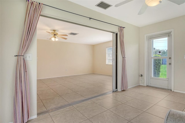 3276 Westford Ln, Sarasota, FL 34231 - empty room with a ceiling fan and light tile patterned floors