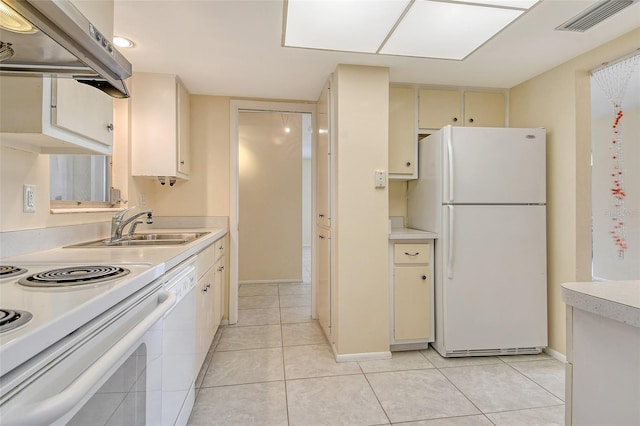 3276 Westford Ln, Sarasota, FL 34231 - kitchen with white appliances, wall chimney range hood, light countertops, cream cabinetry, and light tile patterned flooring