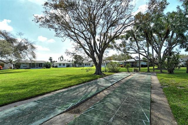 3276 Westford Ln, Sarasota, FL 34231 - view of property's community with shuffleboard and a lawn