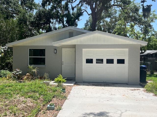 4740 Garcia Ave, Sarasota, FL 34233 - view of front of house with driveway, a garage, and stucco siding