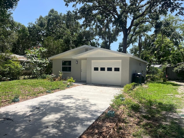 4740 Garcia Ave, Sarasota, FL 34233 - view of front of property with an attached garage, concrete driveway, and stucco siding