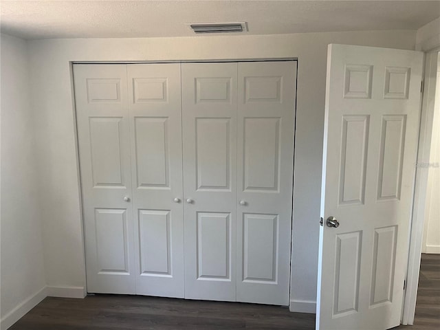 4740 Garcia Ave, Sarasota, FL 34233 - unfurnished bedroom featuring dark wood finished floors and a closet