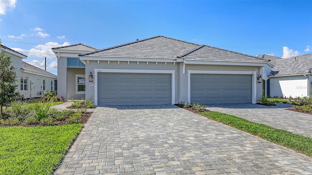 2321 Blue Mahoe Ln, Sarasota, FL 34240 - ranch-style home with stucco siding, decorative driveway, an attached garage, and a tiled roof