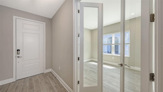 2321 Blue Mahoe Ln, Sarasota, FL 34240 - corridor featuring wood finished floors and baseboards