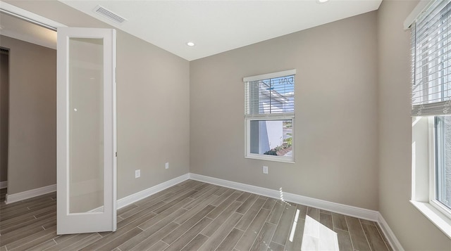 2321 Blue Mahoe Ln, Sarasota, FL 34240 - unfurnished bedroom featuring baseboards, wood finished floors, and recessed lighting