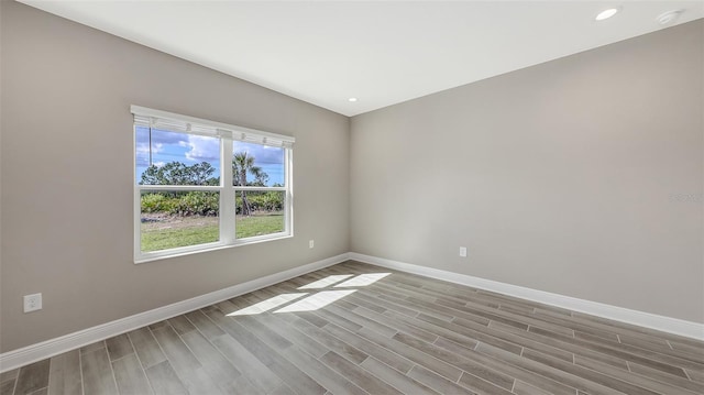 2321 Blue Mahoe Ln, Sarasota, FL 34240 - empty room with baseboards, wood finished floors, recessed lighting, and a smoke detector