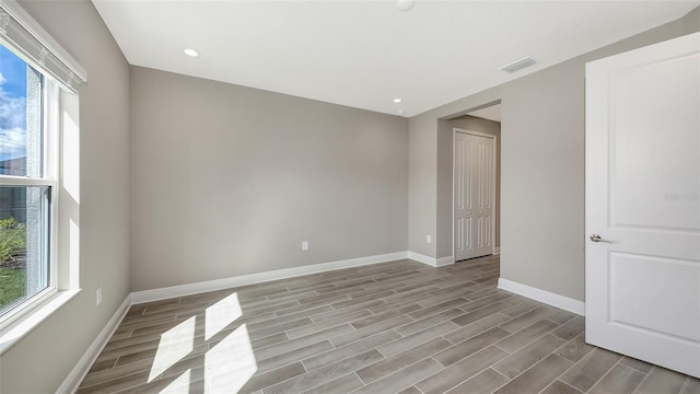 2321 Blue Mahoe Ln, Sarasota, FL 34240 - unfurnished room featuring baseboards, wood finished floors, and recessed lighting
