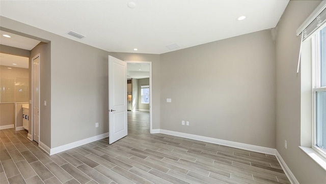 2321 Blue Mahoe Ln, Sarasota, FL 34240 - unfurnished bedroom with baseboards, light wood-style flooring, recessed lighting, and connected bathroom