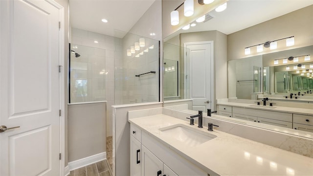 2321 Blue Mahoe Ln, Sarasota, FL 34240 - full bathroom featuring a walk in shower, vanity, and wood finished floors