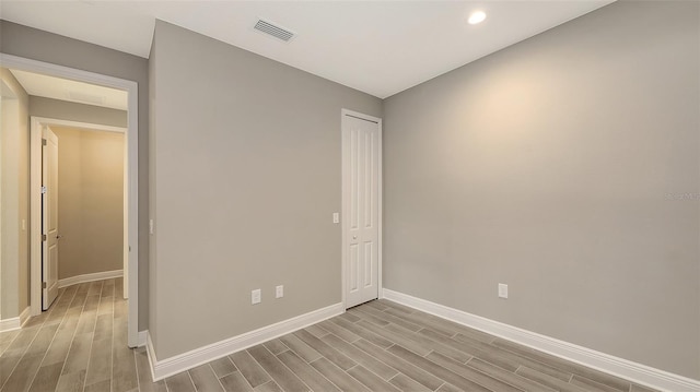 2321 Blue Mahoe Ln, Sarasota, FL 34240 - unfurnished bedroom featuring wood finished floors, baseboards, a closet, and recessed lighting