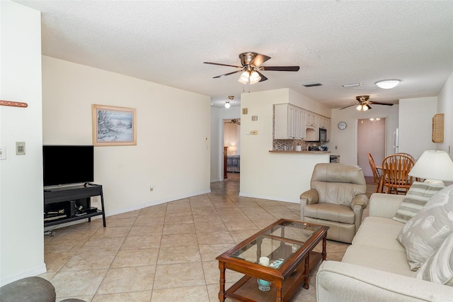 4165 66th Street Cir W Unit H, Bradenton, FL 34209 - living area featuring ceiling fan, light tile patterned floors, and a textured ceiling
