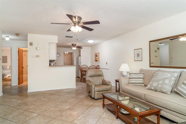 4165 66th Street Cir W Unit H, Bradenton, FL 34209 - living room with a ceiling fan, a textured ceiling, and light tile patterned floors