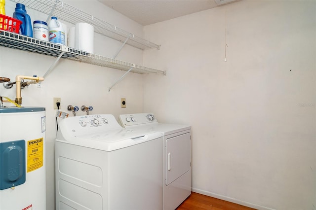 4165 66th Street Cir W Unit H, Bradenton, FL 34209 - washroom featuring water heater, washing machine and clothes dryer, light wood-style flooring, and attic access