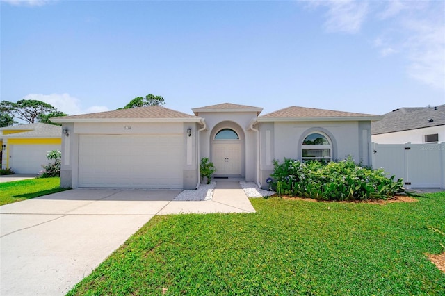 5410 Matthew Ct, Sarasota, FL 34231 - mediterranean / spanish-style home with an attached garage, stucco siding, and driveway