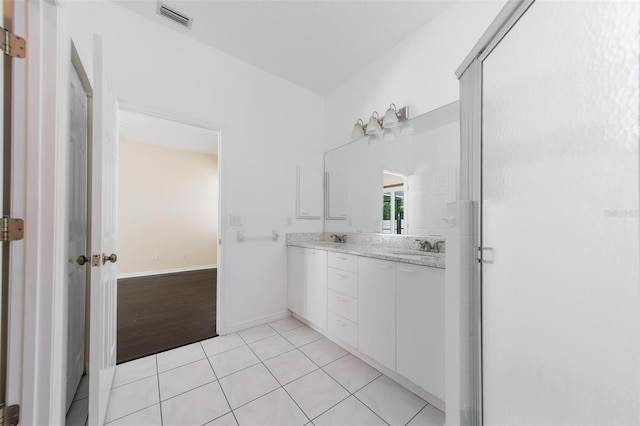 5410 Matthew Ct, Sarasota, FL 34231 - full bath with double vanity, tile patterned floors, and a stall shower