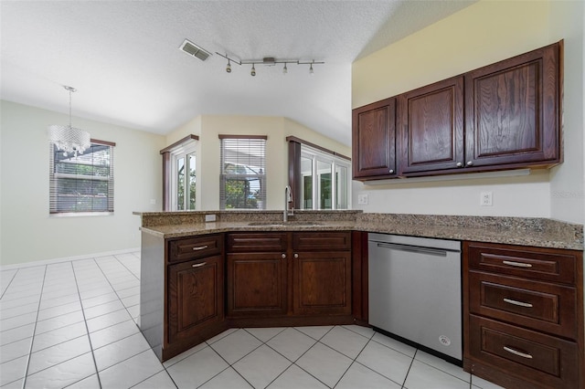 5410 Matthew Ct, Sarasota, FL 34231 - kitchen with stainless steel dishwasher, a peninsula, a chandelier, light tile patterned flooring, and lofted ceiling