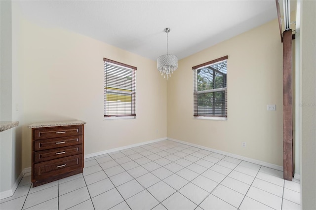 5410 Matthew Ct, Sarasota, FL 34231 - spare room with a chandelier and light tile patterned floors