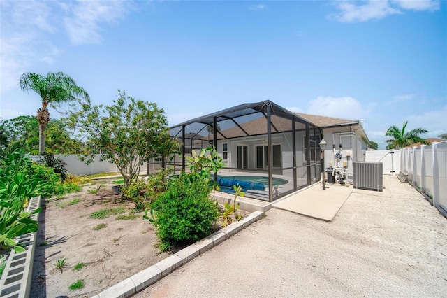 5410 Matthew Ct, Sarasota, FL 34231 - rear view of property featuring a patio, a fenced backyard, and glass enclosure