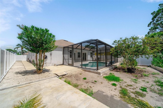5410 Matthew Ct, Sarasota, FL 34231 - rear view of house with a patio area, a fenced backyard, a lanai, and stucco siding