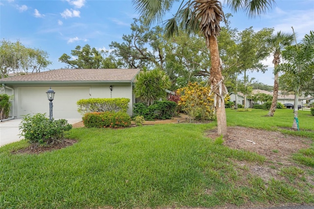 4637 Willow Wood Cir Unit 44, Sarasota, FL 34241 - view of home's exterior featuring driveway, a lawn, and an attached garage