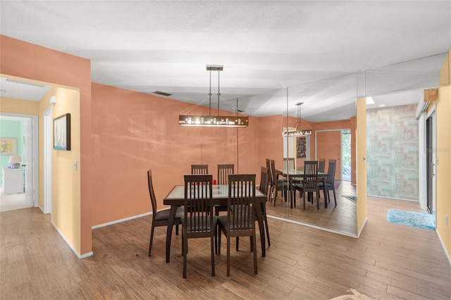 4637 Willow Wood Cir Unit 44, Sarasota, FL 34241 - dining area with wood finished floors and a chandelier