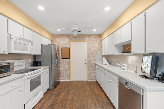 4637 Willow Wood Cir Unit 44, Sarasota, FL 34241 - kitchen featuring appliances with stainless steel finishes, ceiling fan, white cabinets, dark wood-style floors, and light countertops