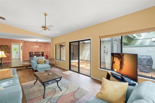 4637 Willow Wood Cir Unit 44, Sarasota, FL 34241 - living room with vaulted ceiling, wood finished floors, ceiling fan, and a chandelier