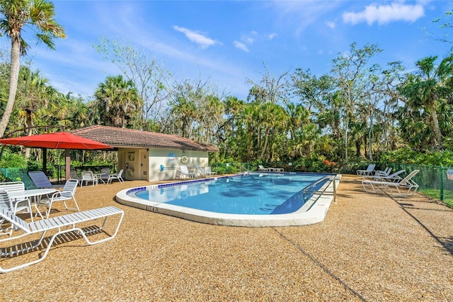 4637 Willow Wood Cir Unit 44, Sarasota, FL 34241 - community pool featuring a patio area and view of scattered trees