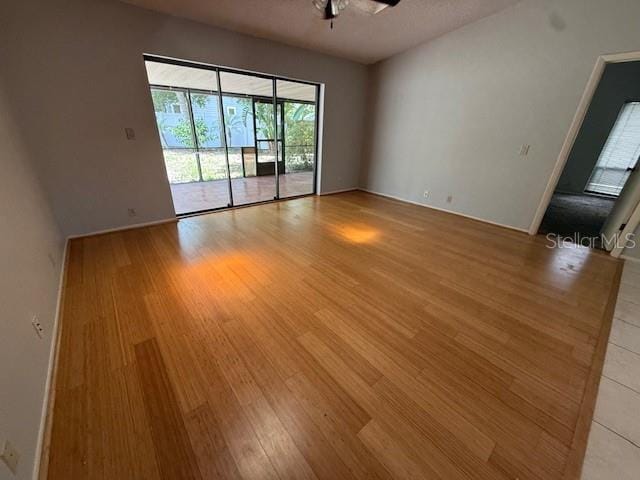 5032 81st Avenue Terrace E, Sarasota, FL 34243 - spare room featuring light wood-type flooring and a ceiling fan