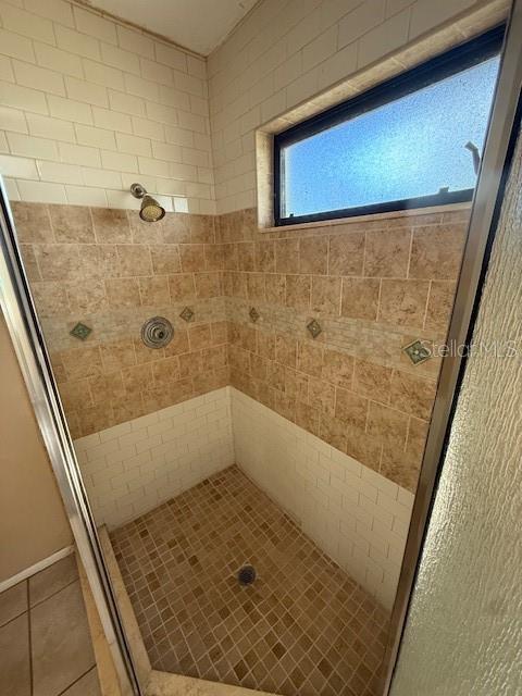 5032 81st Avenue Terrace E, Sarasota, FL 34243 - full bath featuring a stall shower and tile patterned floors