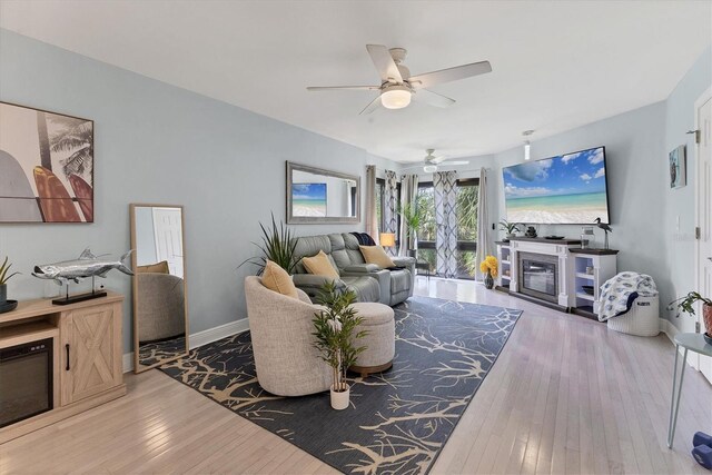 1500 Sunset Rd Unit B4, Tarpon Springs, FL 34689 - living room featuring a ceiling fan, hardwood / wood-style floors, and a glass covered fireplace