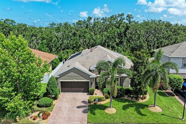5307 65th Ter E, Ellenton, FL 34222 - view of front of house with a garage, decorative driveway, a front lawn, and stucco siding