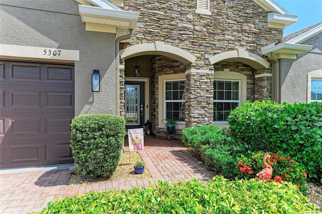 5307 65th Ter E, Ellenton, FL 34222 - entrance to property featuring stucco siding, stone siding, and an attached garage