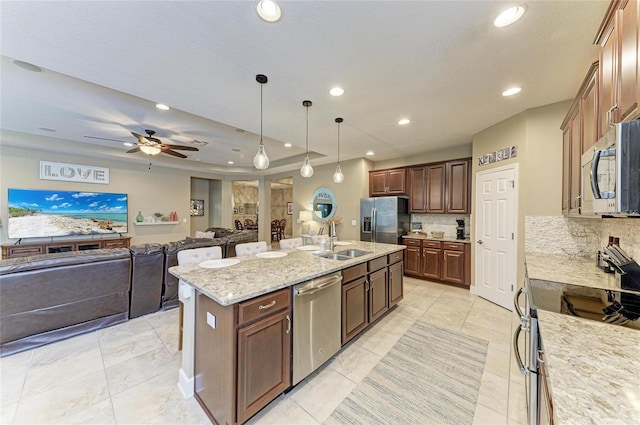 5307 65th Ter E, Ellenton, FL 34222 - kitchen with stainless steel appliances, a sink, tasteful backsplash, recessed lighting, and a kitchen island with sink