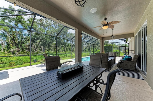 5307 65th Ter E, Ellenton, FL 34222 - view of patio / terrace featuring an outdoor hangout area, an outdoor pool, glass enclosure, ceiling fan, and outdoor dining space