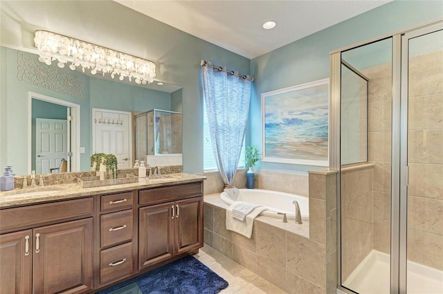 5307 65th Ter E, Ellenton, FL 34222 - bathroom with a stall shower, a garden tub, double vanity, and tile patterned floors