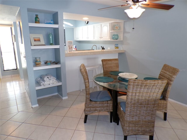 1801 Gulf Dr N Unit 207, Bradenton Beach, FL 34217 - dining area with ceiling fan, built in shelves, and light tile patterned floors