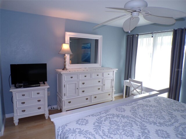 1801 Gulf Dr N Unit 207, Bradenton Beach, FL 34217 - bedroom with light wood-style floors and ceiling fan